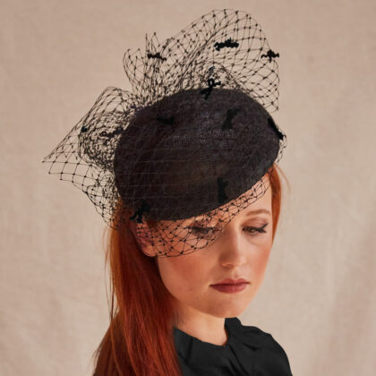 Summer-straw-beret-style-funeral-hat-with-veiling-and-mini-bows-in-black-by-london-milliner-nerida-fraiman-front view